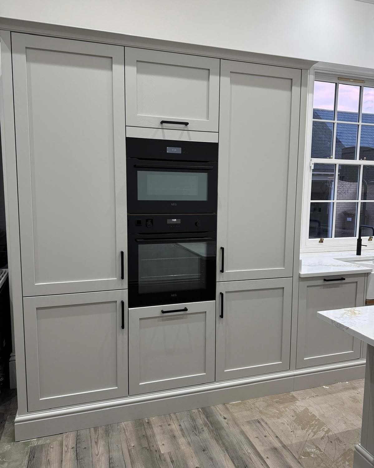 Full-height in-frame kitchen joinery with integrated built-in ovens